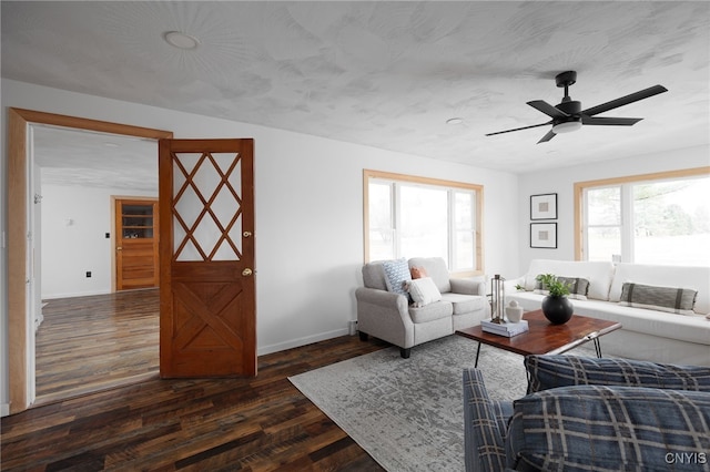 living room with dark hardwood / wood-style floors and ceiling fan