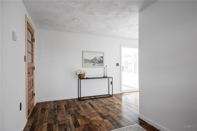 corridor with dark wood-type flooring