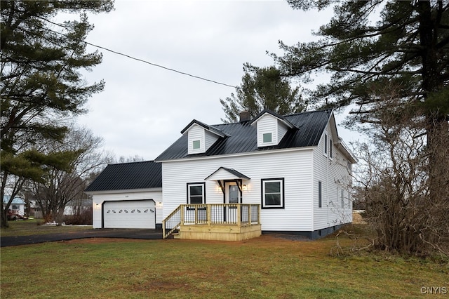 cape cod home featuring a front yard and a garage