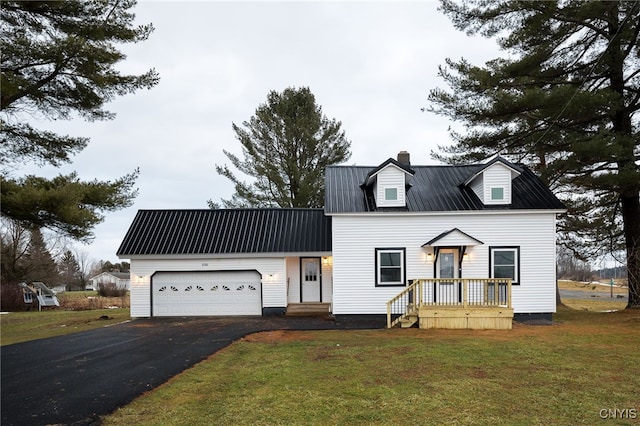 cape cod house featuring a garage and a front lawn