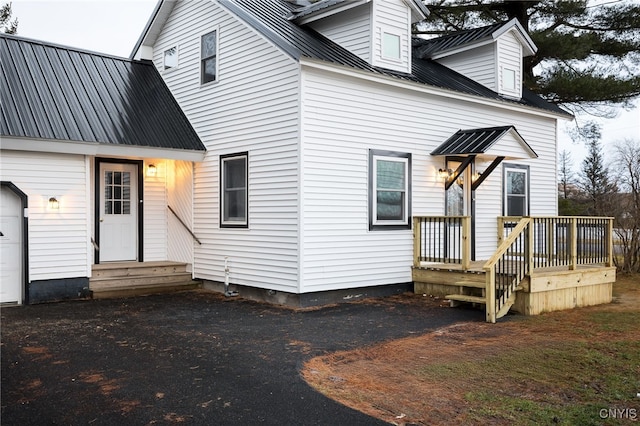 back of house featuring a garage