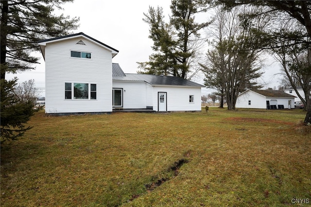 back of property featuring a lawn