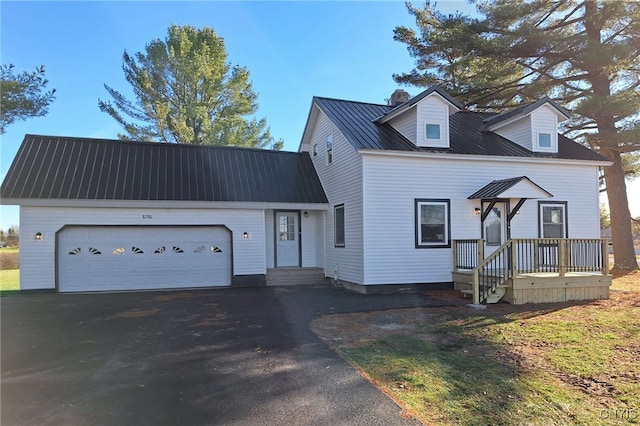 cape cod-style house featuring a garage