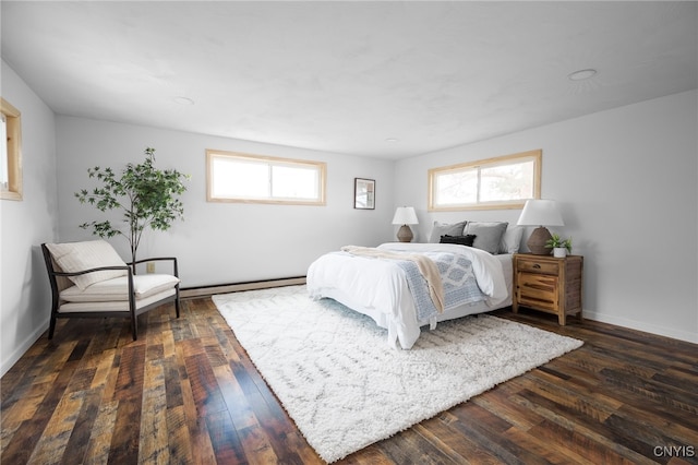 bedroom with a baseboard radiator and dark hardwood / wood-style floors