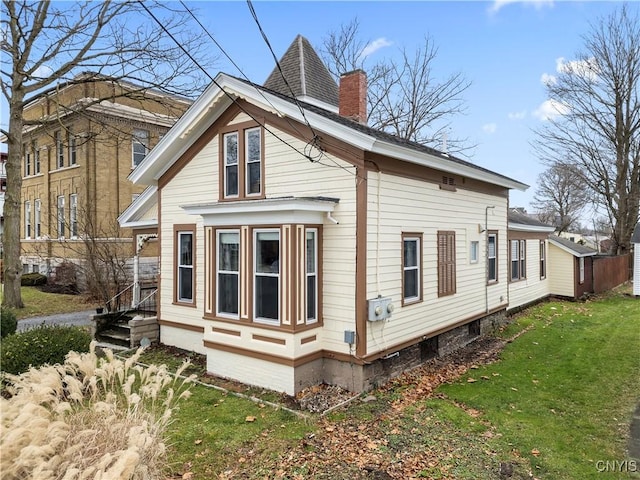 view of property exterior featuring a lawn