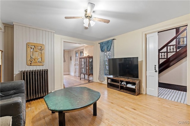 living room featuring ceiling fan, wood-type flooring, and radiator