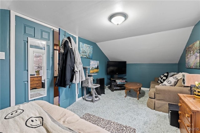 bedroom featuring carpet floors and vaulted ceiling