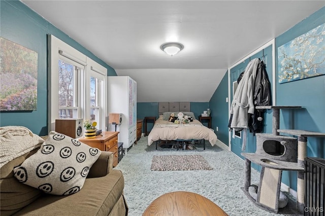 bedroom featuring hardwood / wood-style floors and vaulted ceiling