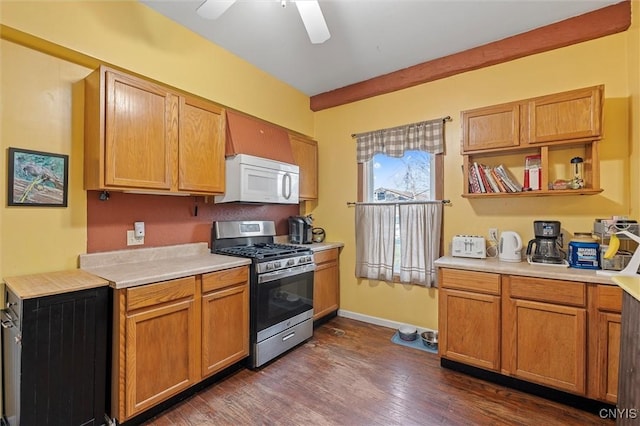 kitchen with gas range, ceiling fan, and dark hardwood / wood-style floors