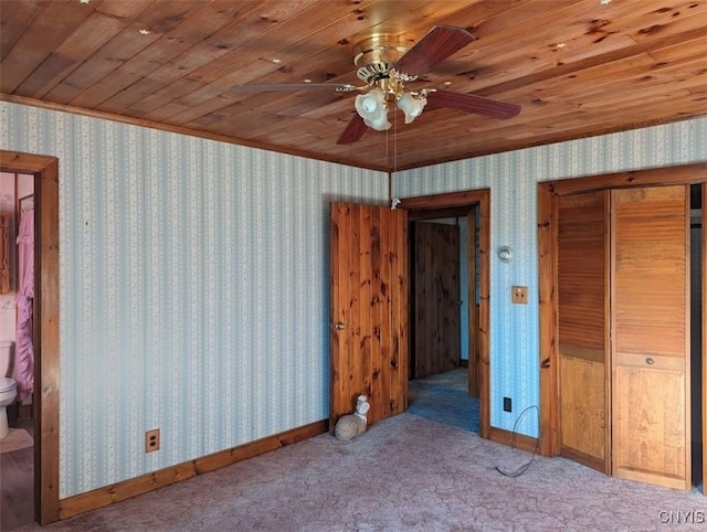 unfurnished bedroom with ceiling fan, light colored carpet, wooden ceiling, and connected bathroom