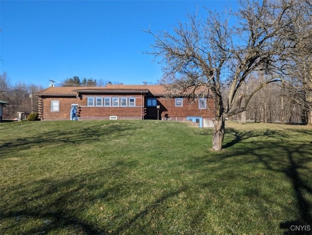 rear view of house with a lawn