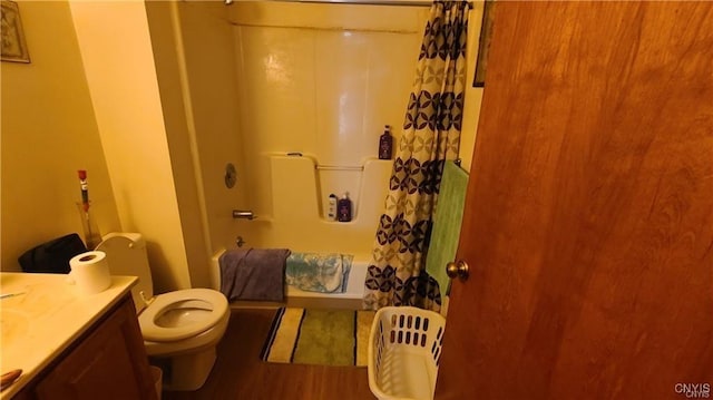 full bathroom with hardwood / wood-style floors, vanity, toilet, and shower / tub combo