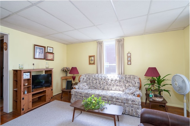 living room featuring hardwood / wood-style floors and a drop ceiling