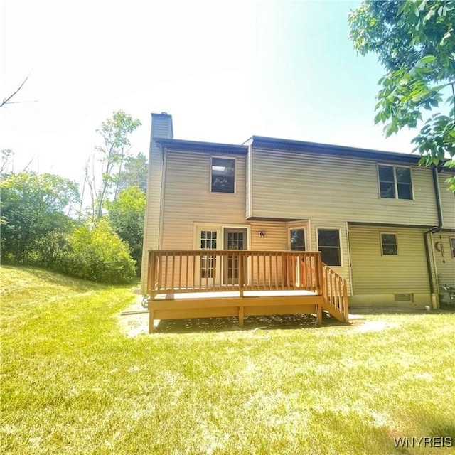 rear view of house with a yard and a deck