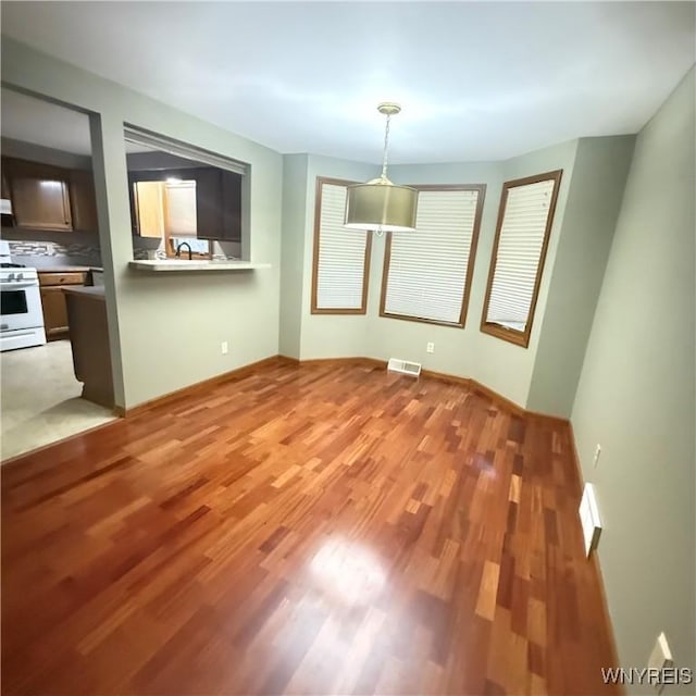 unfurnished dining area with wood-type flooring