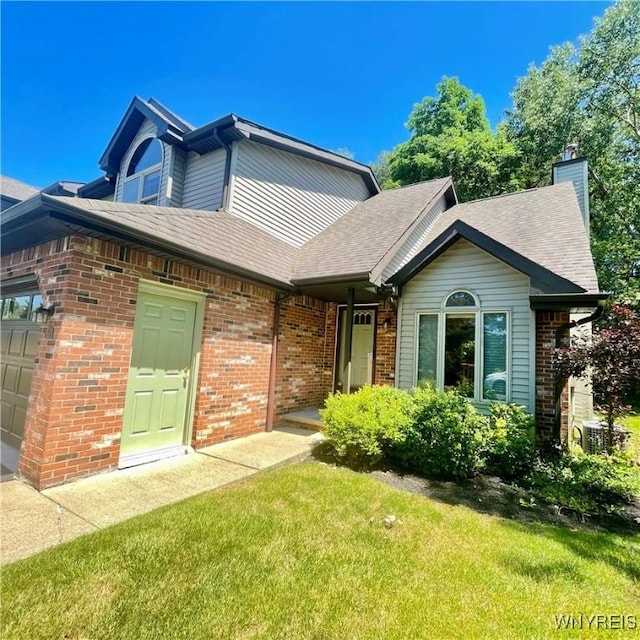 view of front of home with a front yard and a garage