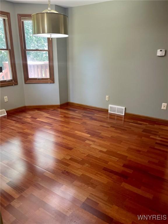 empty room with hardwood / wood-style floors