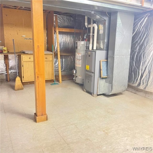 basement with a workshop area, heating unit, and gas water heater