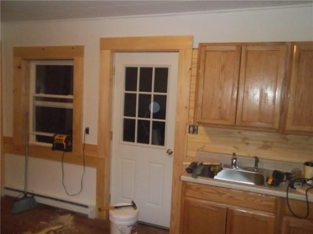 kitchen with a baseboard heating unit, sink, and tasteful backsplash