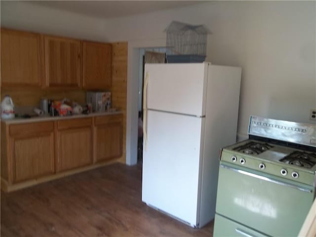 kitchen with white appliances and dark wood-type flooring