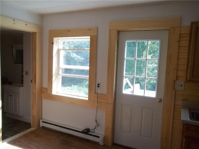 entryway featuring dark hardwood / wood-style floors, baseboard heating, and sink