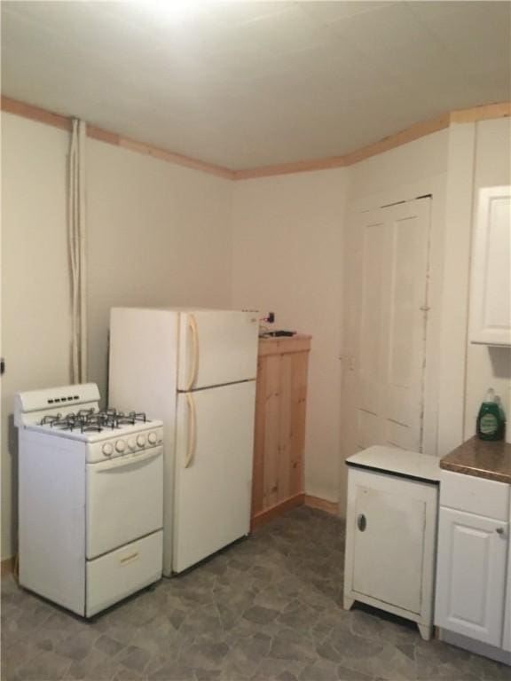 kitchen with white cabinetry and white appliances