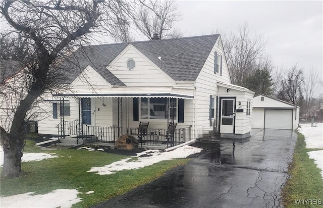 view of front facade with a front yard, a garage, and an outdoor structure