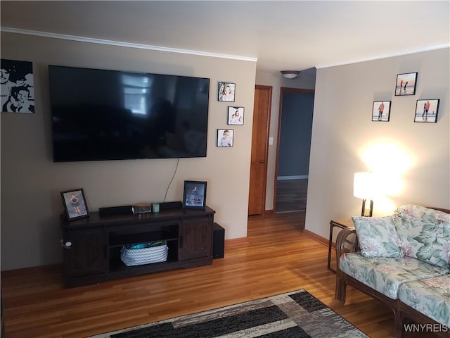 living room featuring crown molding and hardwood / wood-style flooring