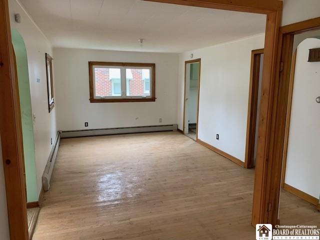 spare room featuring light hardwood / wood-style flooring and baseboard heating