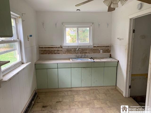 kitchen featuring ceiling fan, plenty of natural light, green cabinets, and sink