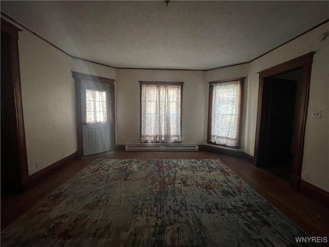 unfurnished room featuring a baseboard radiator and dark hardwood / wood-style floors