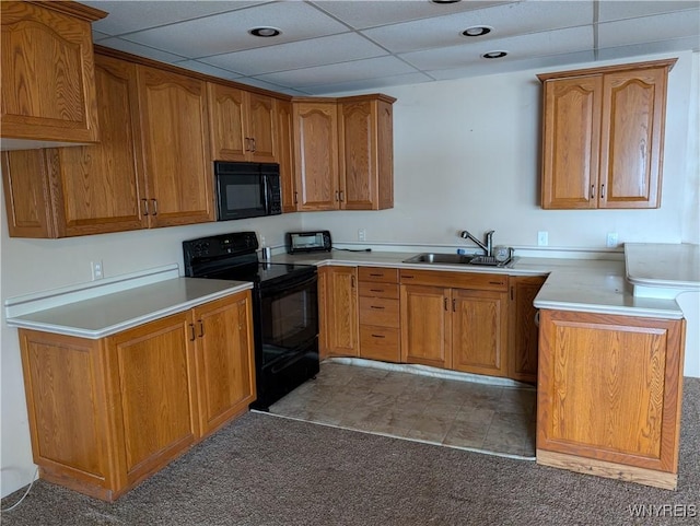 kitchen with dark colored carpet, sink, a drop ceiling, and black appliances