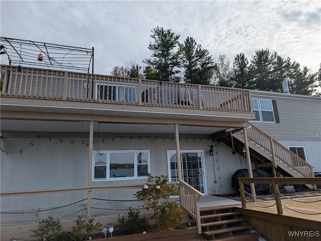 back of property featuring a wooden deck