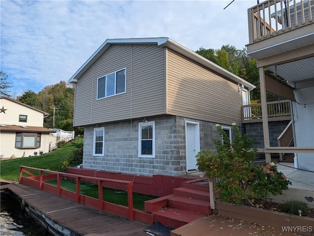 rear view of property featuring a yard