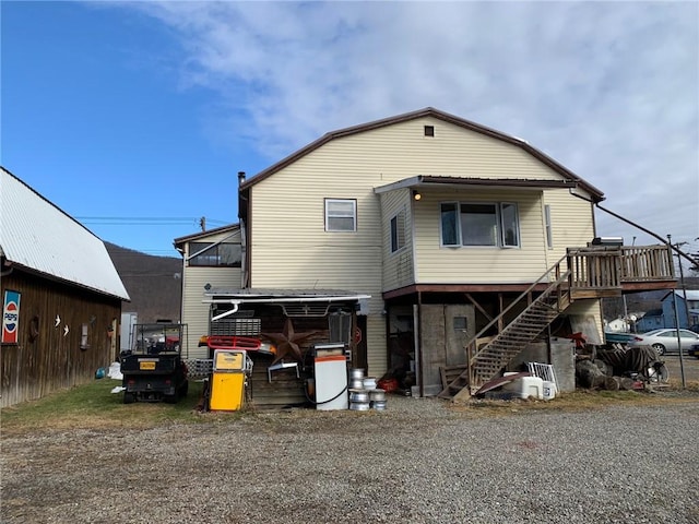 back of house with a wooden deck