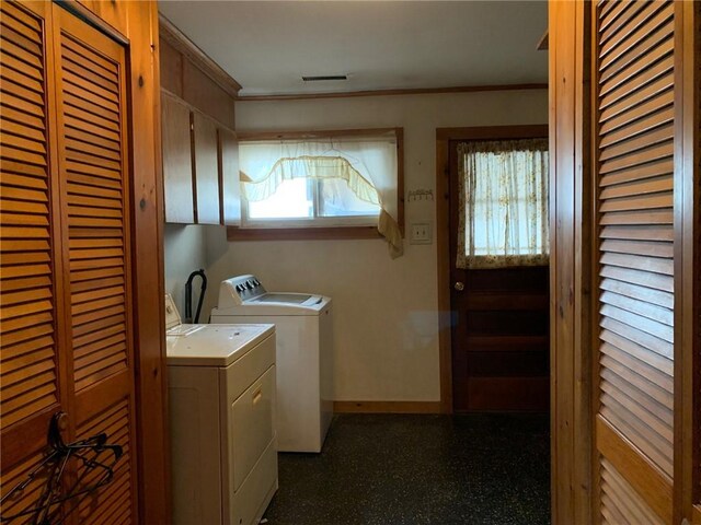 laundry area featuring separate washer and dryer, a wealth of natural light, and crown molding