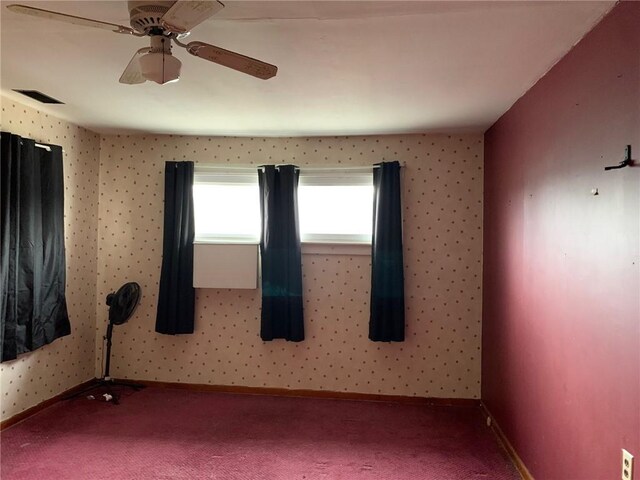 carpeted empty room featuring ceiling fan