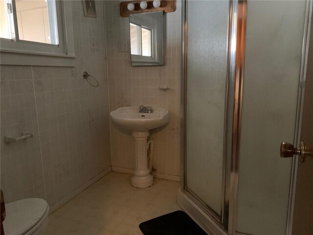 bathroom with an enclosed shower and toilet