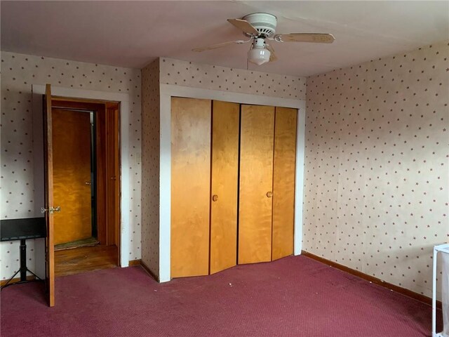 unfurnished bedroom featuring carpet, a closet, and ceiling fan