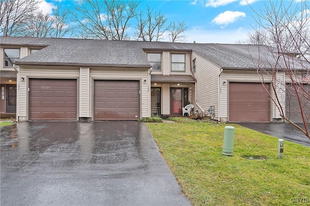 view of front of property featuring a front lawn and a garage