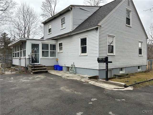 rear view of property with a sunroom