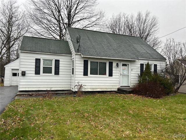 cape cod home with a front yard and a garage