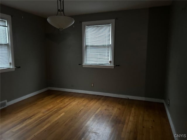 spare room with hardwood / wood-style floors