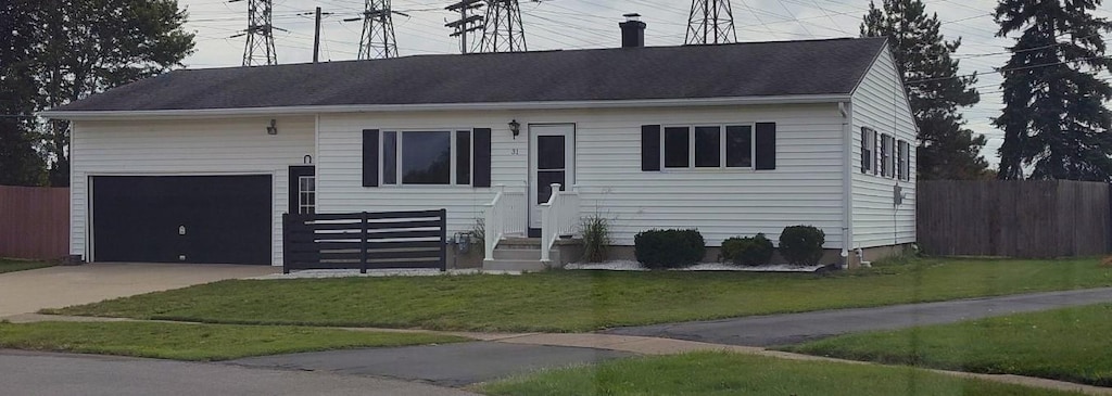 ranch-style house with a garage and a front lawn