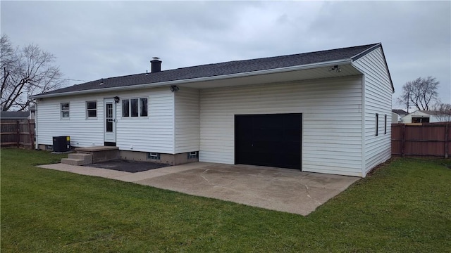 rear view of house featuring a lawn, a patio, and central AC