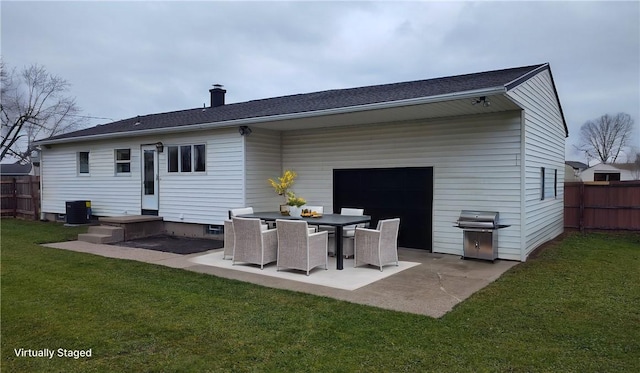 rear view of house with cooling unit, a patio area, and a lawn