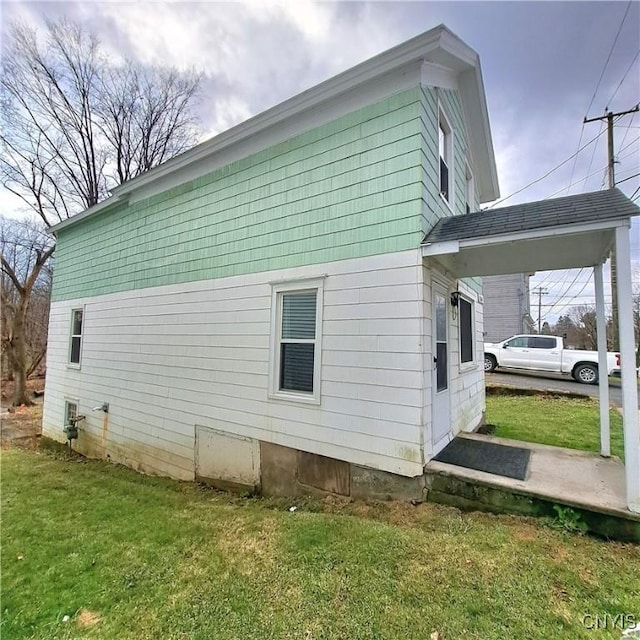 view of property exterior with a lawn