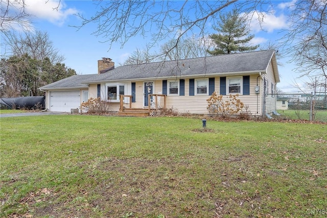 single story home featuring a front lawn and a garage