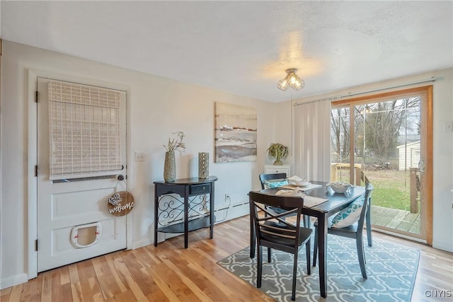 dining space with wood-type flooring