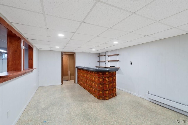 bar featuring a drop ceiling and baseboard heating